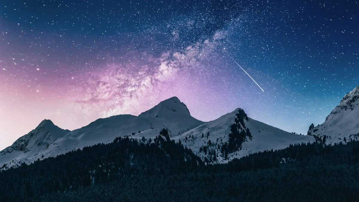 A starry night sky with the Milky Way and a shooting star arcing above snowy mountain peaks - a Quiet Core Reset guide to 5-Minute Rest & Digest Reset.
