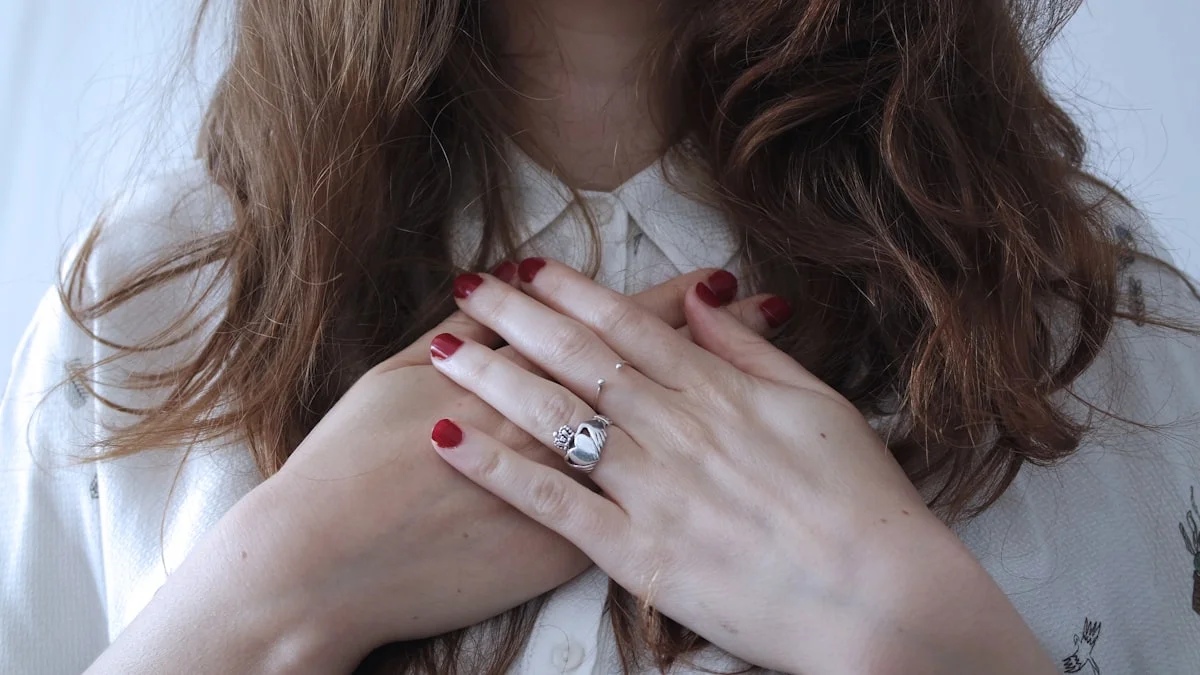 A woman resting both hands flat over her chest in soft, even light - a Quiet Core Reset guide to The 90-Second Reset After a Comparison Spiral.