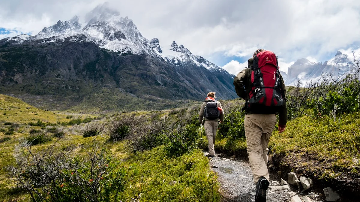 Two hikers walking at an easy pace up a green mountain trail in soft morning light - a Quiet Core Reset guide to Ambition Without Burnout.