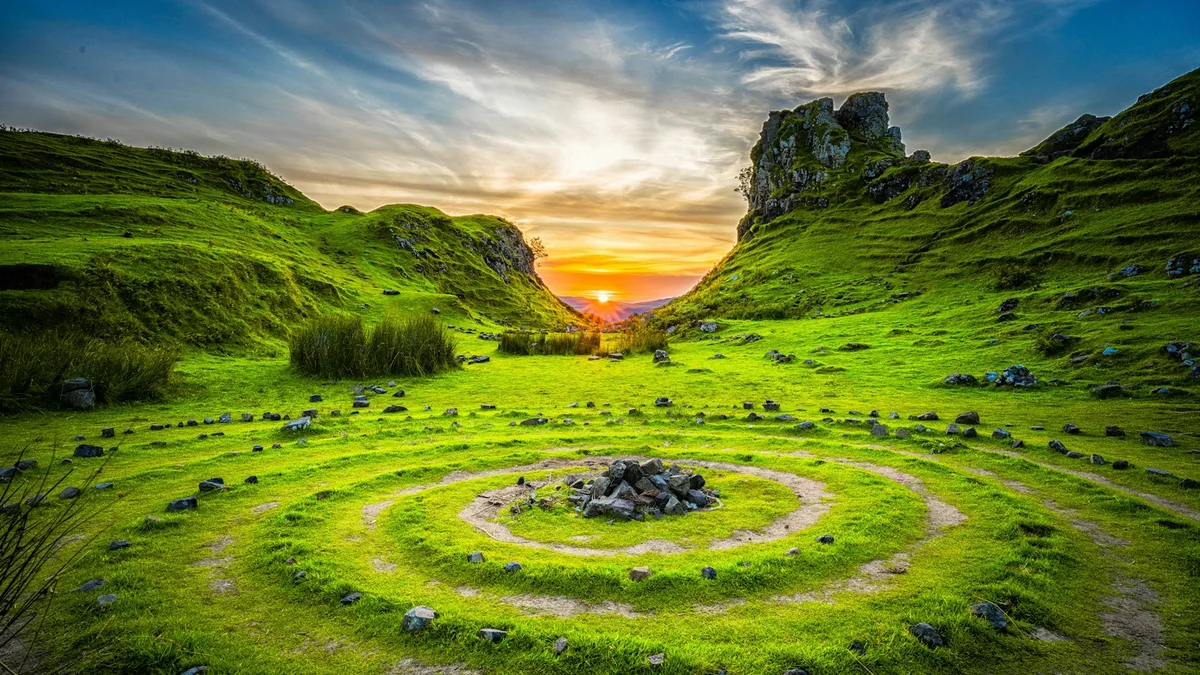 A vivid green land-art spiral labyrinth in a valley with a rock cairn at center, sunset over the hills - a Quiet Core Reset guide to From Chaos to Calm.