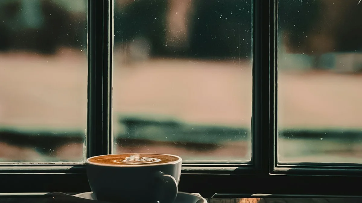 A latte on a wooden windowsill beside rain-soft glass, a small warm pause - a Quiet Core Reset guide to Setting Boundaries When You're Already Burned Out.