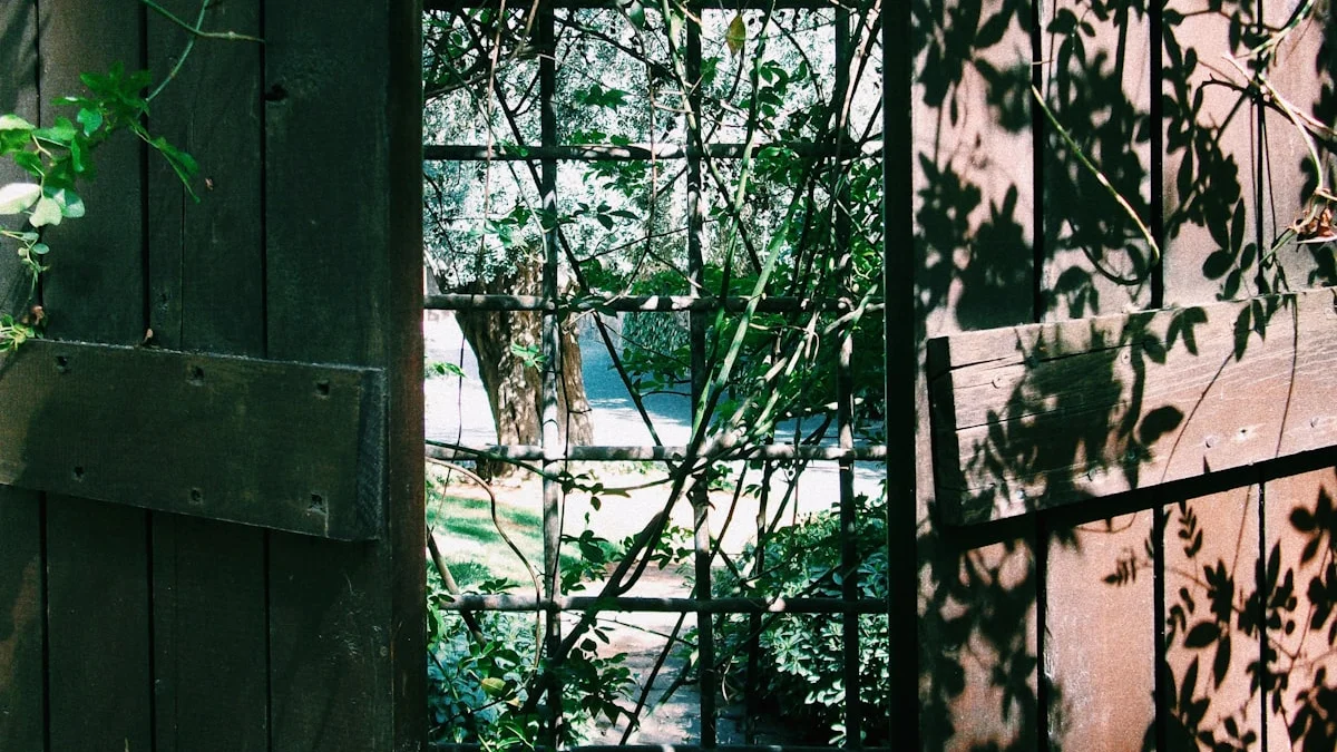 A weathered wooden garden gate stands half-open, leaf shadows falling across its planks - a Quiet Core Reset guide to Common Boundary Mistakes (and the Gentler Fix).