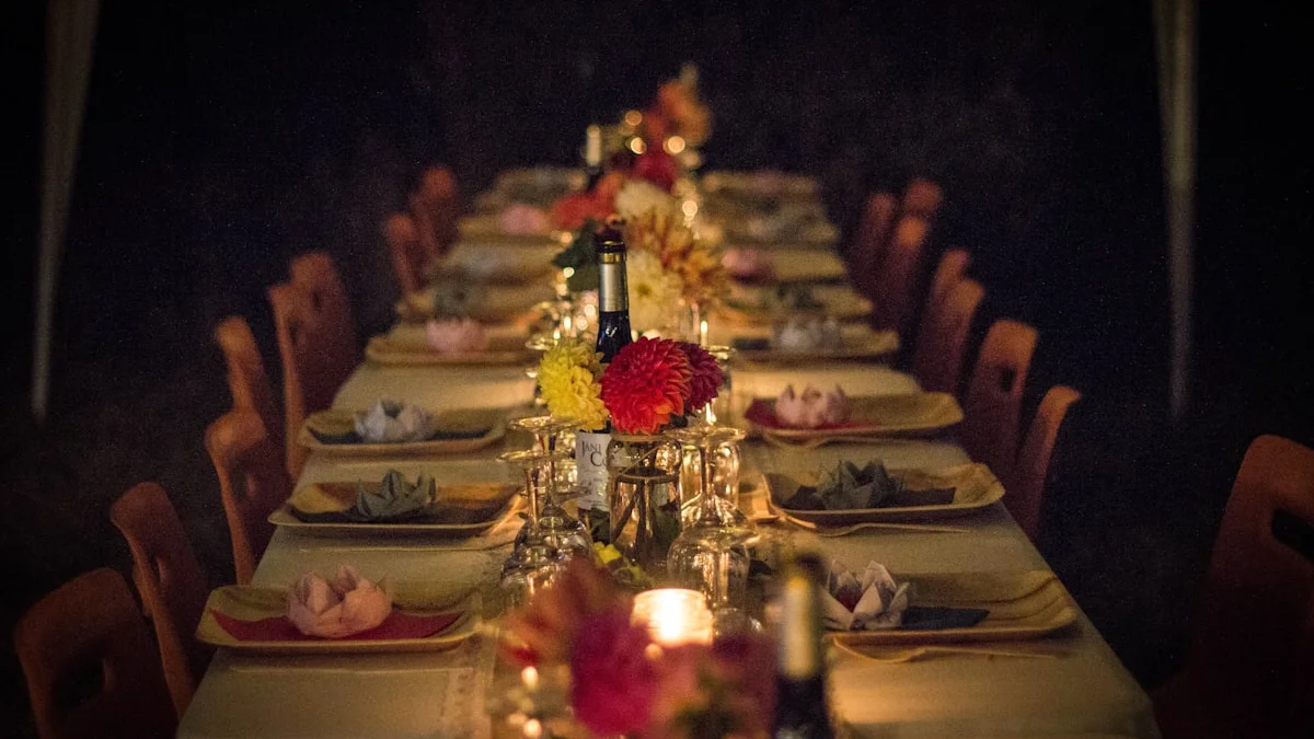 A long dinner table set with plates, flowers and candles glowing warmly in the evening - a Quiet Core Reset guide to Boundaries With Family.