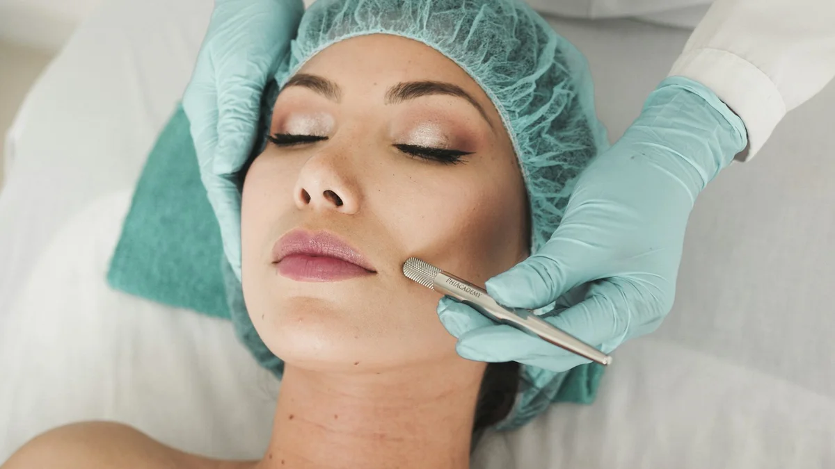 A person receiving a facial treatment, a practitioner in gloves using a tool on the cheek - a Quiet Core Reset guide to Breathing Reset Card.
