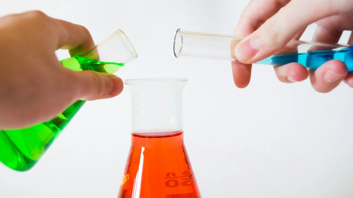 Hands pouring colored liquid between laboratory glassware, chemistry flasks - a Quiet Core Reset guide to Myths About Burnout Recovery, Debunked.