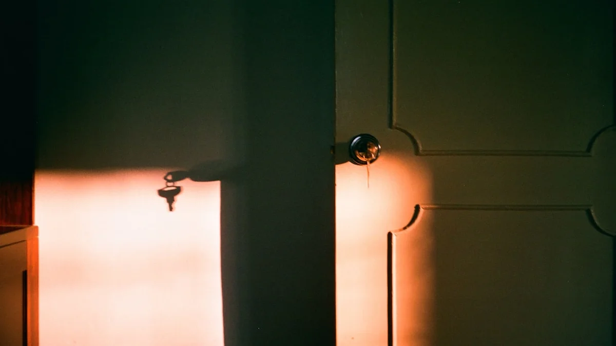 Warm evening light falls across a door and a wall with keys hanging nearby - a Quiet Core Reset guide to Coming Home to Your Feelings: A Quiet Core Reset.