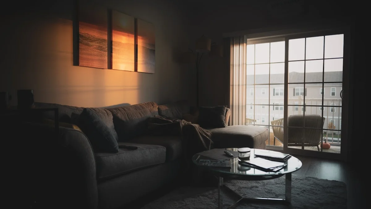 A dim living room at dusk with a corner couch, glass coffee table, and warm light glowing on framed wall art - a Quiet Core Reset guide to the Comparison Treadmill.