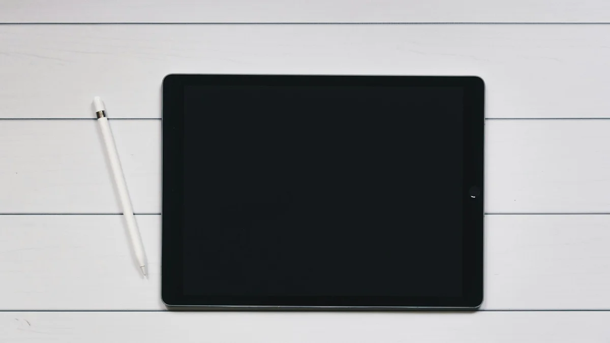 A tablet and stylus resting on white lined paper, a clean minimal desk - a Quiet Core Reset guide to Connect With Your Values.