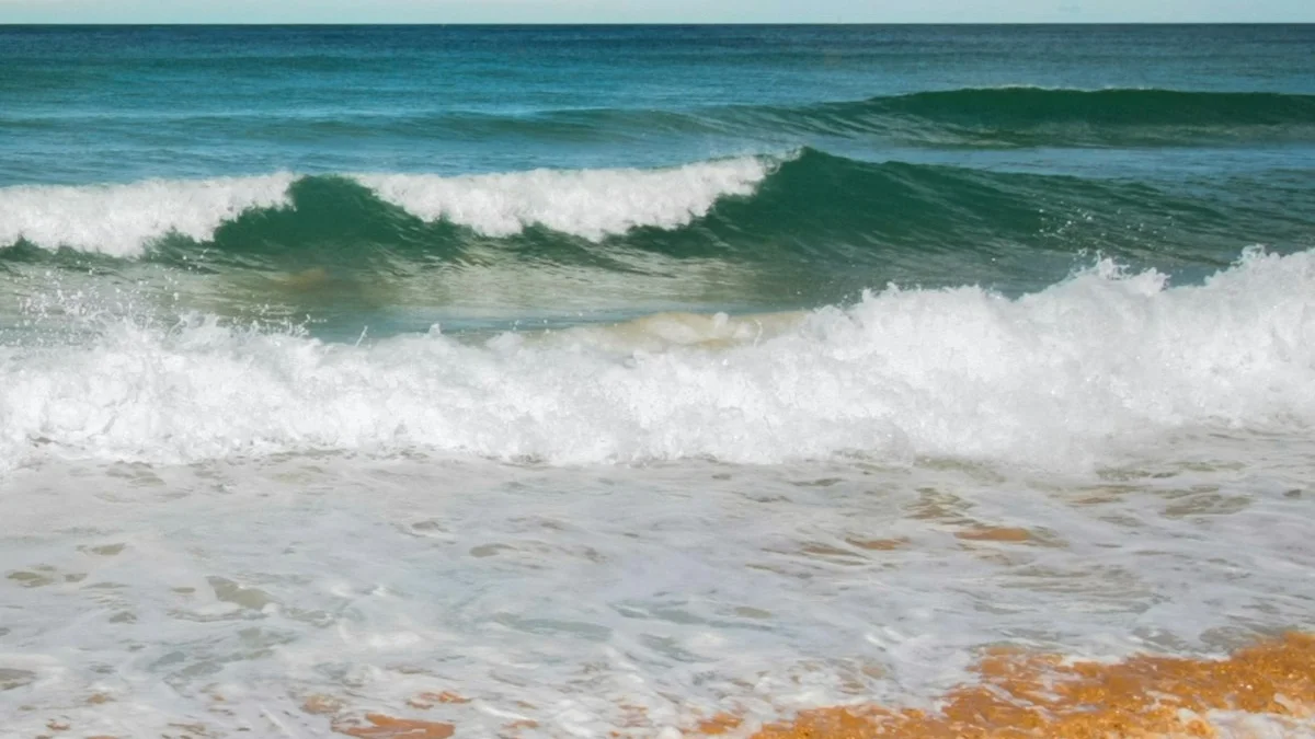 Waves rising and falling as they roll toward a warm sandy shore - a Quiet Core Reset guide to Emotions Are Waves, Not Weights.