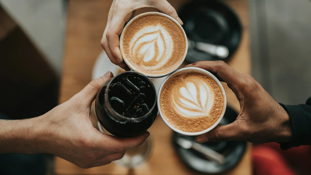 Three hands toasting with cups of coffee and affogato, a cozy gathering - a Quiet Core Reset guide to Energy Management.