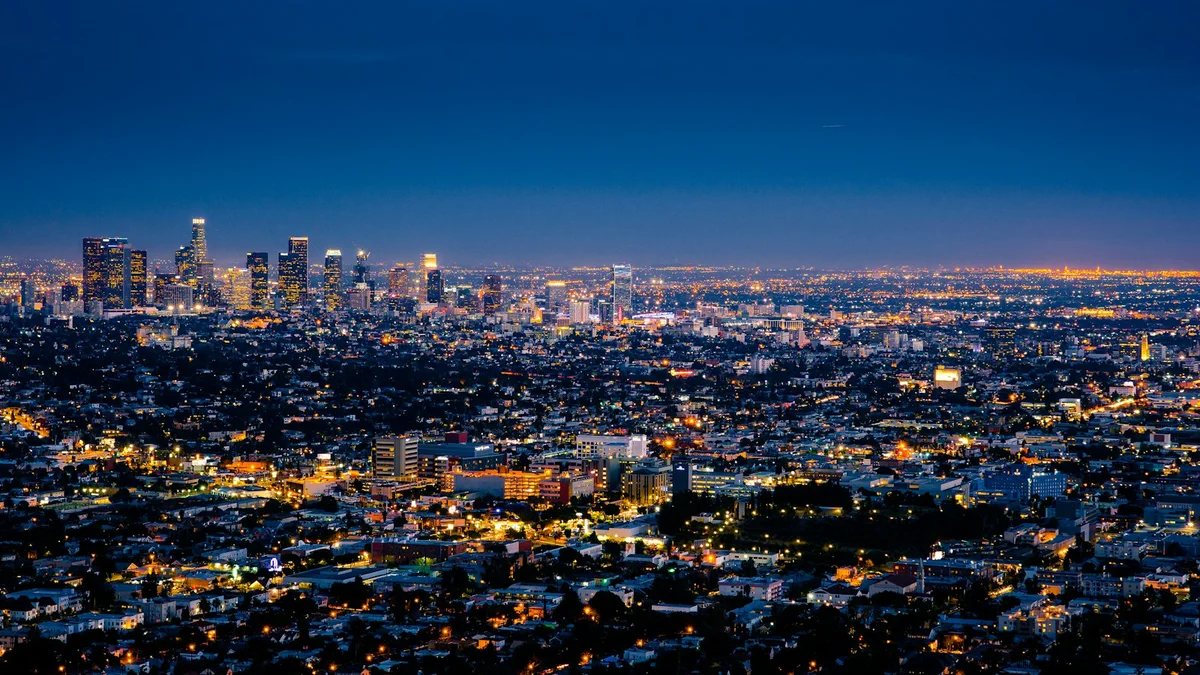 A sprawling city skyline at night glittering with thousands of lights - a Quiet Core Reset guide to Why Energy Management Is So Hard in a 24/7 World.