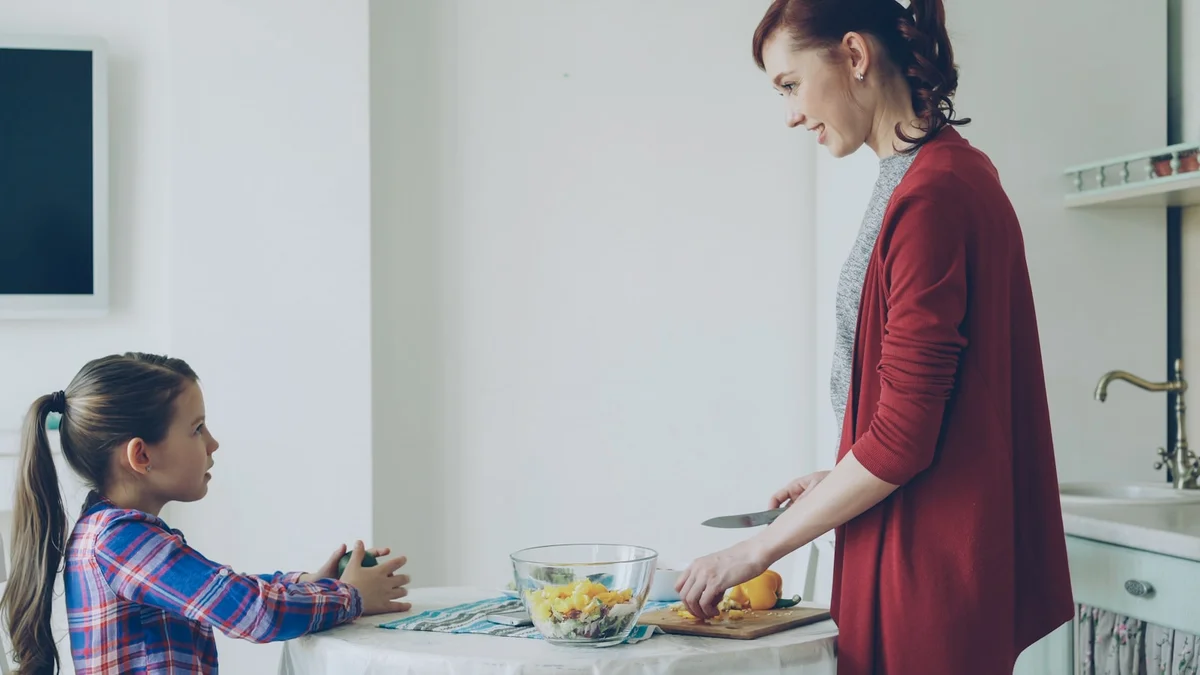 A warm kitchen evening scene with a parent and child at the table under soft lamplight - a Quiet Core Reset guide to Family Energy.