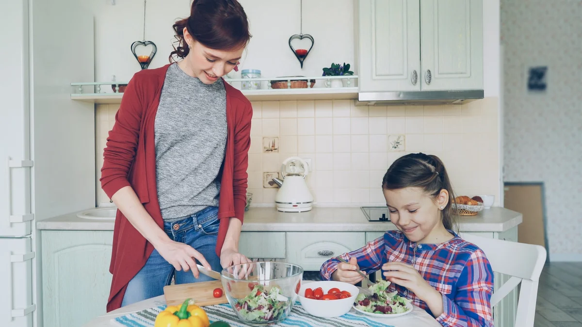 A mother and daughter preparing dinner together in a warm kitchen - a Quiet Core Reset guide to Family Time on Low-Energy Days.