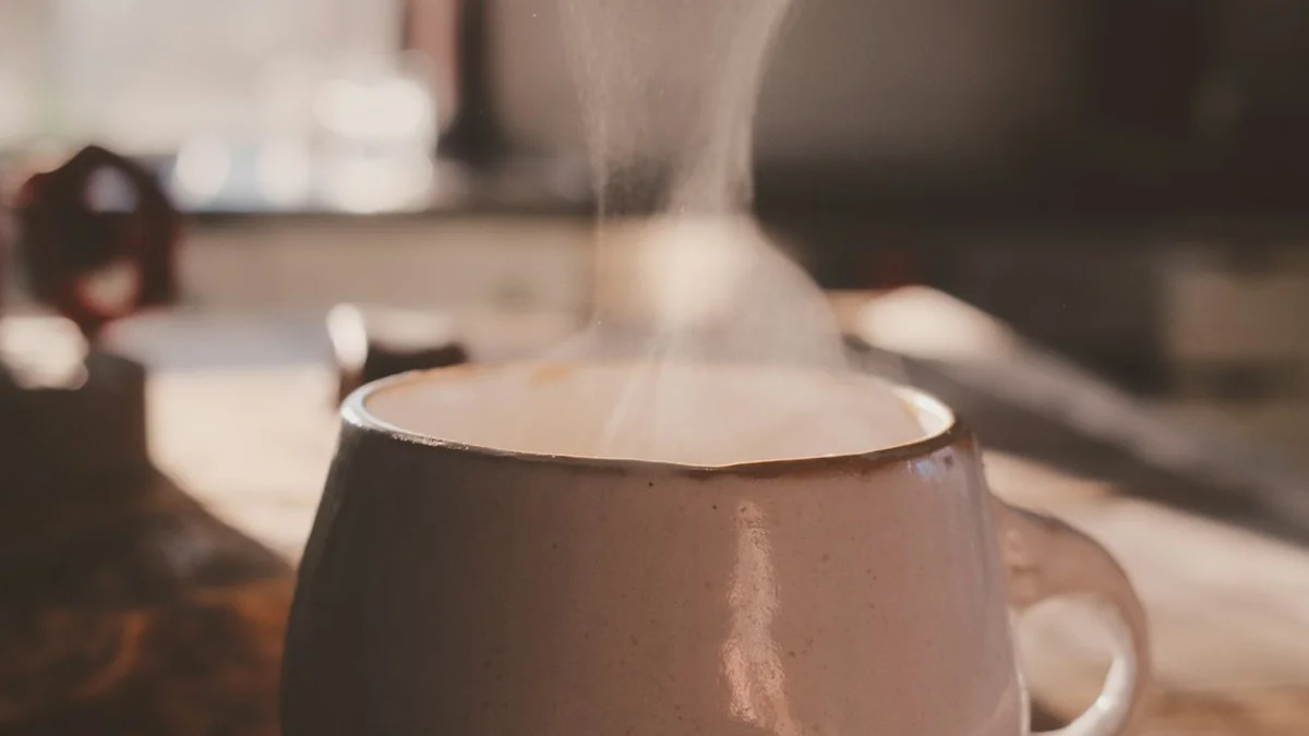 Steam rising from a warm ceramic mug in soft, low light - a Quiet Core Reset guide to From Numbness to Feeling.