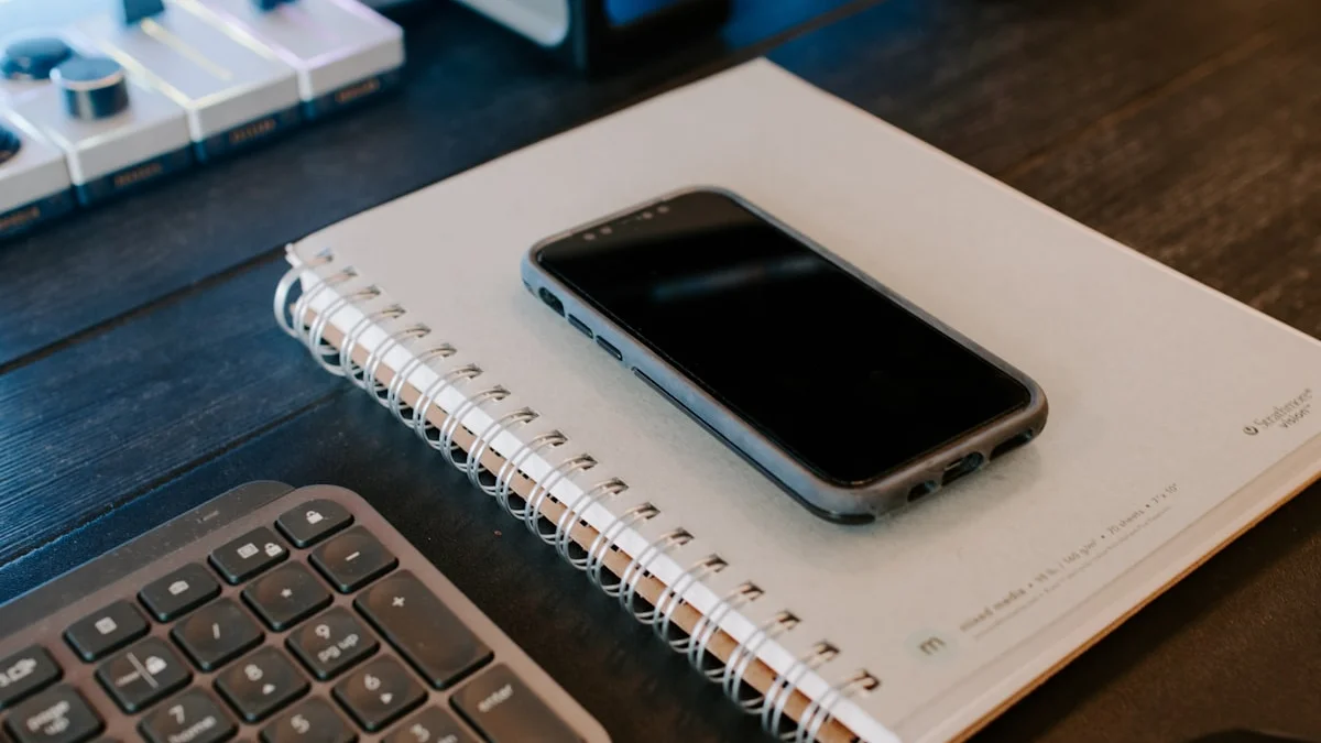 A smartphone lying face down on an open notebook beside a keyboard - a Quiet Core Reset guide to How to Do a Notification Audit in 10 Minutes.