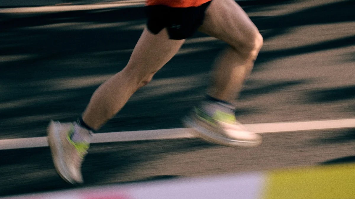A runner's legs stride in motion blur along a dark road, still pushing the pace - a Quiet Core Reset guide to Hustle Culture vs. Human Limits: 'Push Through' Backfires.