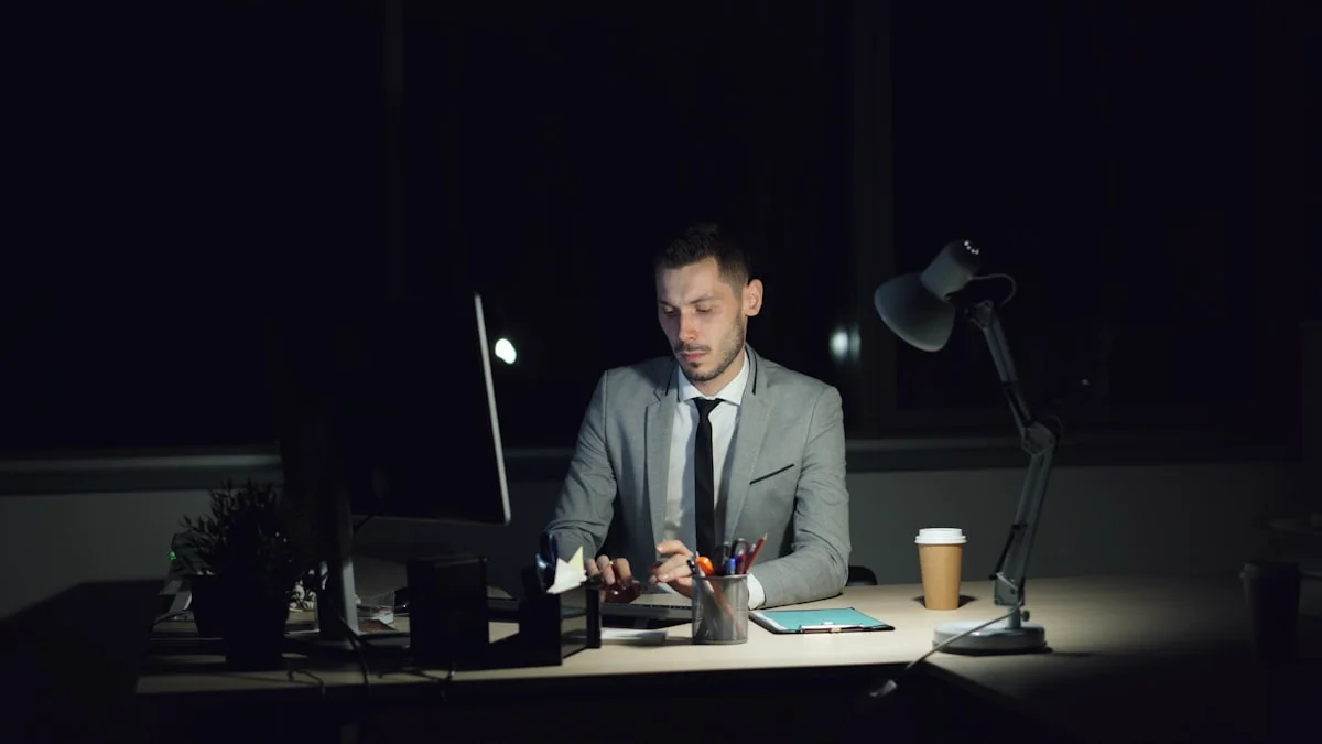 A man in a suit working alone at a lamplit desk late at night, coffee at his elbow - a Quiet Core Reset guide to Hustle Culture.