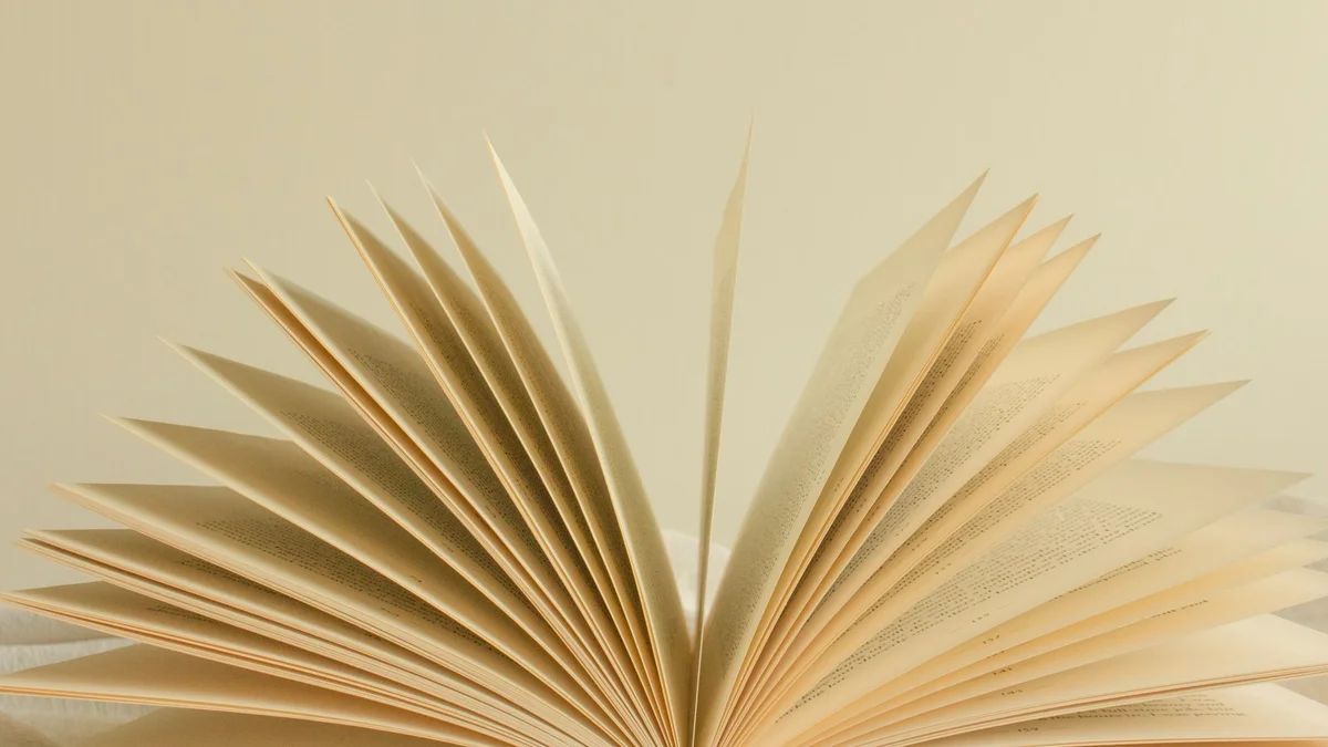 An open book with pages fanned wide in soft cream light - a Quiet Core Reset guide to Inner Critic FAQ.