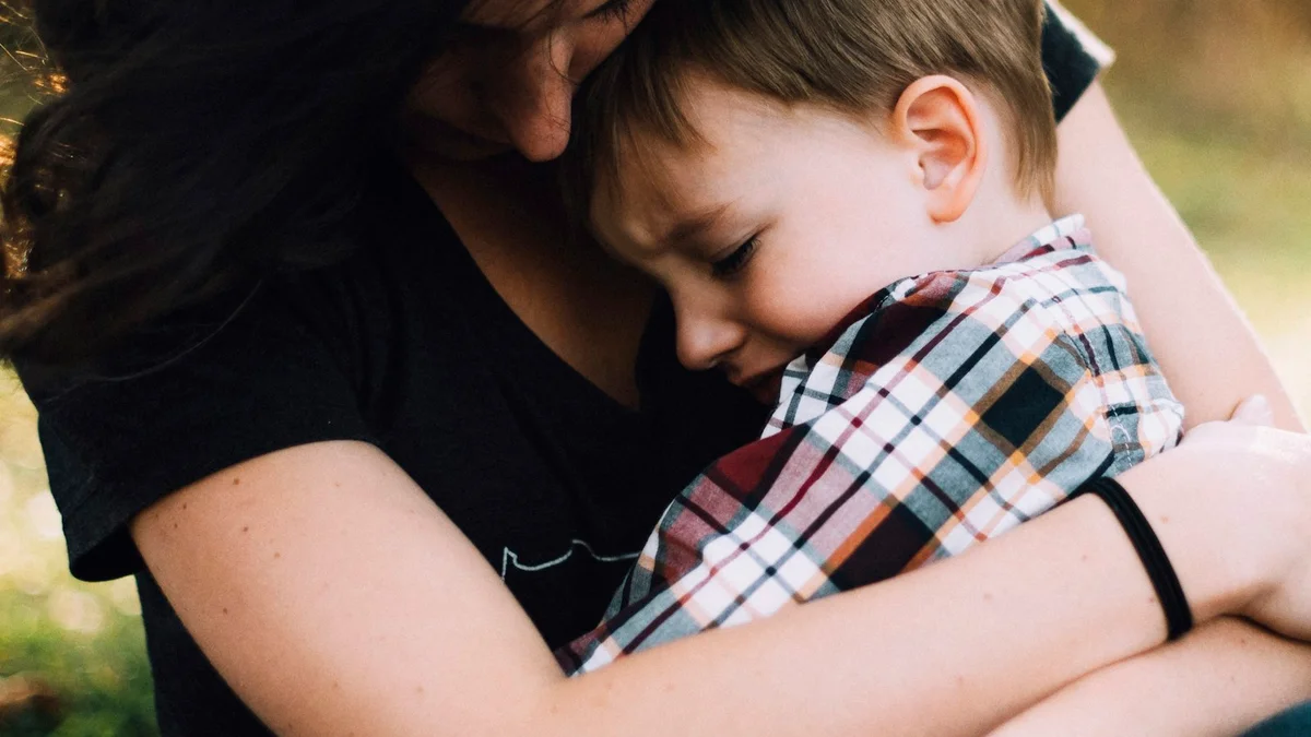 A parent resting forehead to forehead with a young child in golden light - a Quiet Core Reset guide to Inner Critic on Hard Parenting Days.
