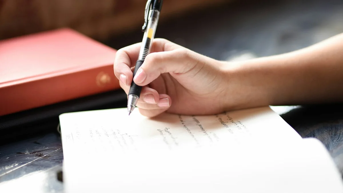 A hand writing honestly in an open journal near a bright window - a Quiet Core Reset guide to A 3-Minute Inner Critic Self-Check (Be Honest, Be Kind).