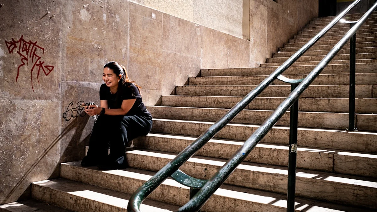 A woman resting on sunlit stone steps halfway up a long staircase - a Quiet Core Reset guide to Just Push Through Makes High-Functioning Exhaustion Worse.