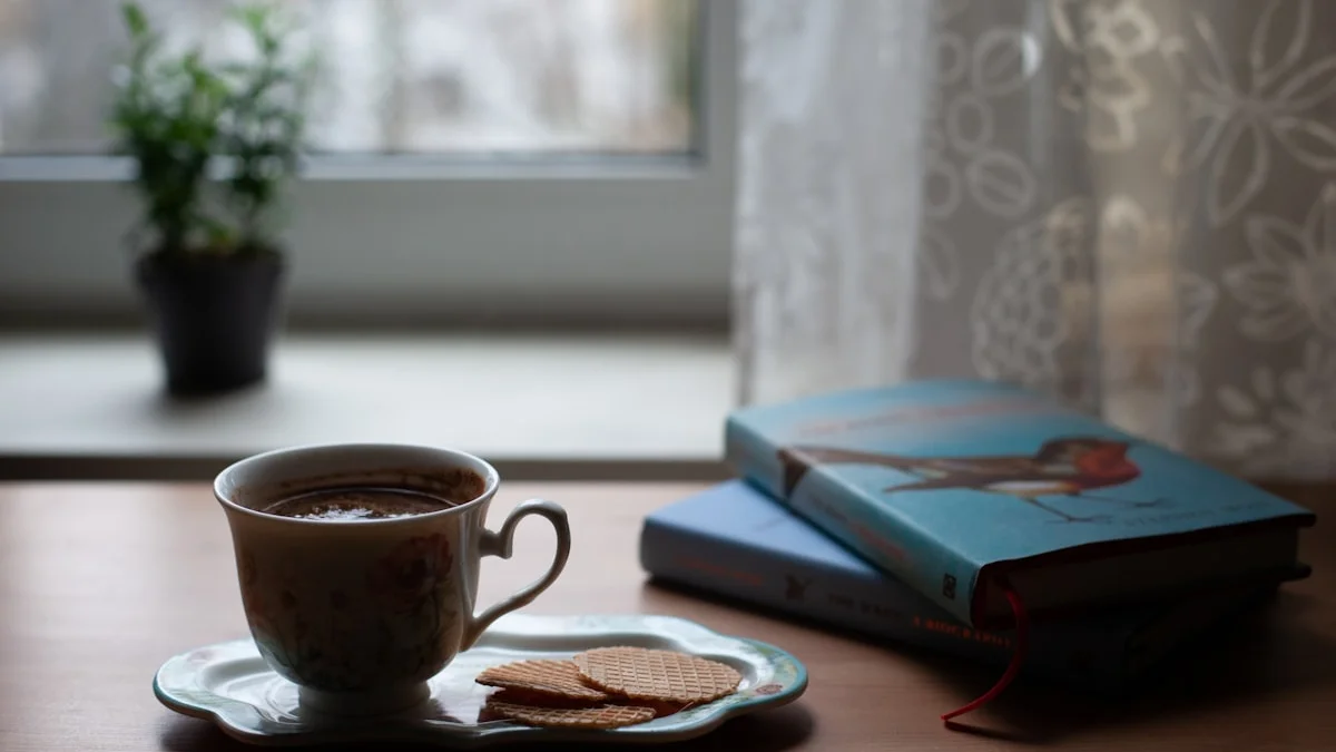 A cup of tea, cookies, and well-read books on a wooden table by a bright window - a Quiet Core Reset guide to Myths About Nervous System Regulation, Debunked.