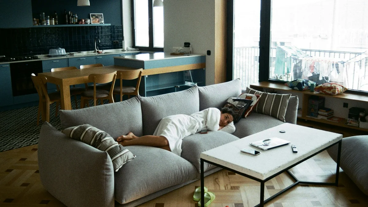 A parent resting on the couch in a quiet living room - a Quiet Core Reset guide to Why You Have No Energy Left for the People You Love (6 Causes).