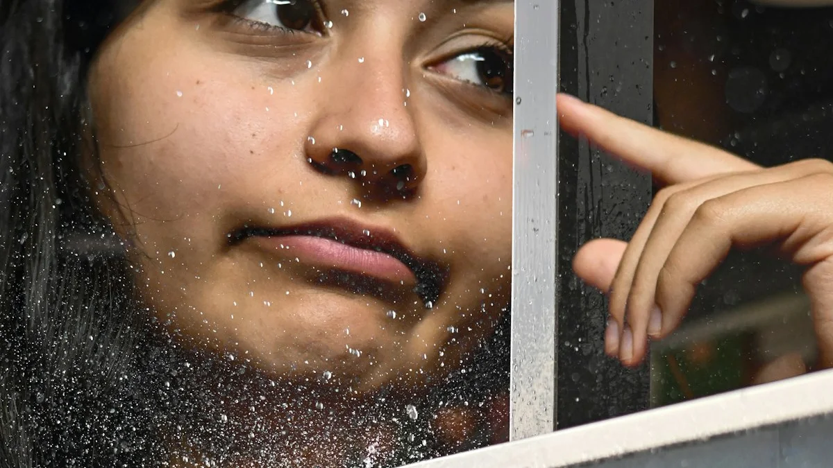 A pensive woman rests her fingers on rain-speckled glass, gazing away in thought - a Quiet Core Reset guide to No 'Negative' Emotions.