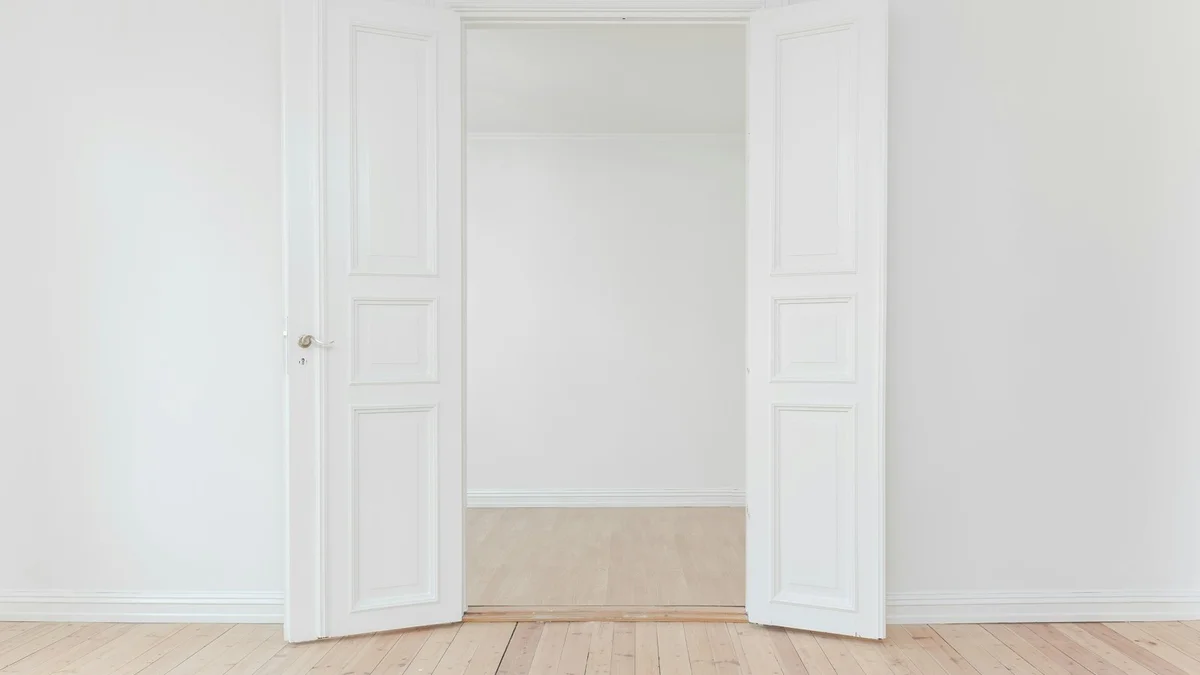 An open empty white double wardrobe or closet, bright and minimal - a Quiet Core Reset guide to From Over-Giving to Intentional Living.