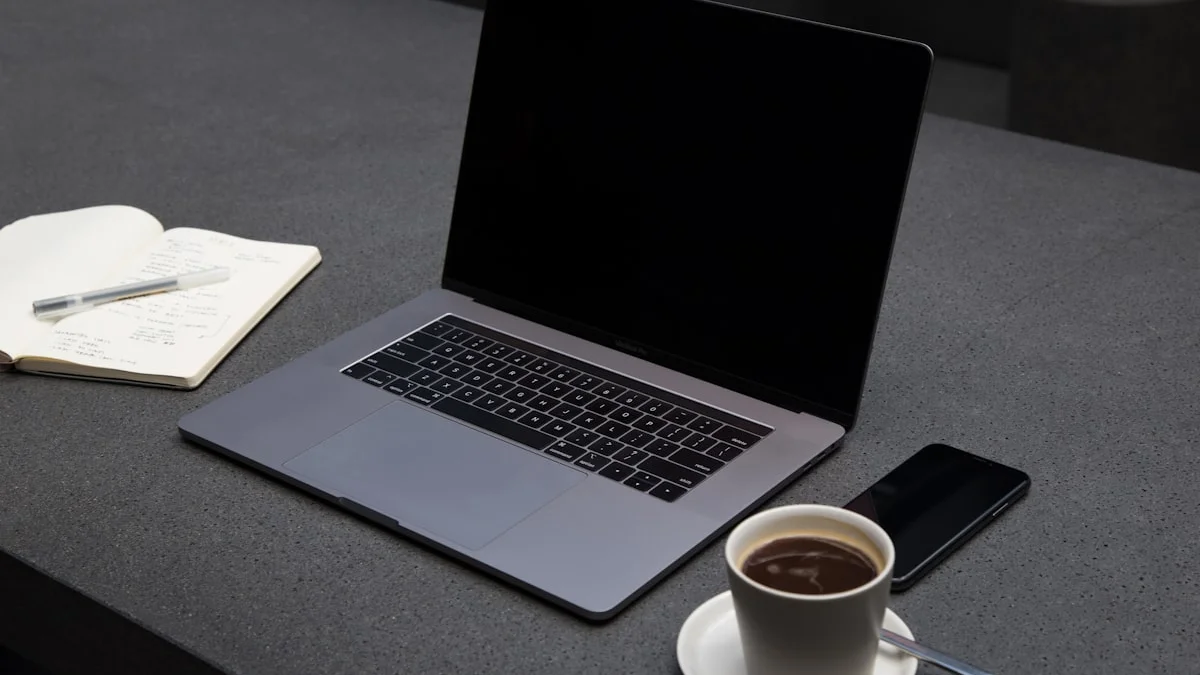 A laptop, an open notebook, and a cup of coffee arranged on a calm grey desk - a Quiet Core Reset guide to Regulate Your Nervous System at Work Without Leaving Your Desk.