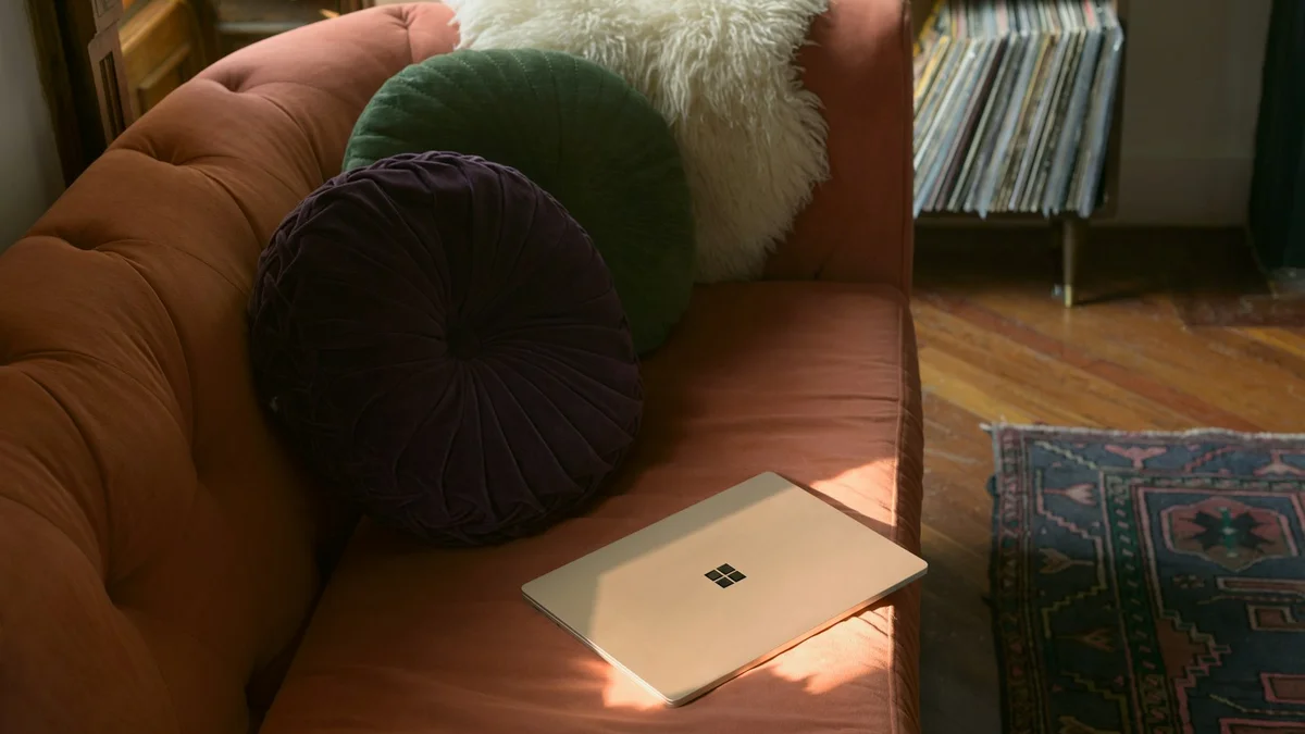 A closed laptop lying on a living room couch in warm afternoon light - a Quiet Core Reset guide to Remote Work Energy.
