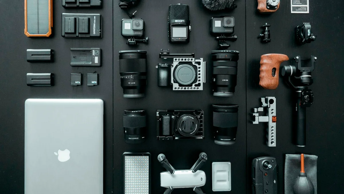 Photography gear and cameras laid out neatly on a dark surface, a kit flat-lay - a Quiet Core Reset guide to What Science Says About Screen Fatigue.