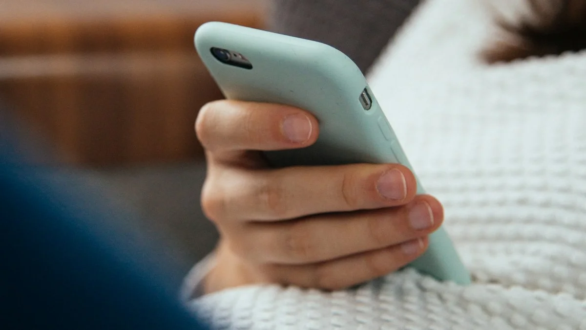 A hand holding a mint-green phone over a cozy blanket, a scroll that never quite restores - a Quiet Core Reset guide to Why Scrolling Isn't Resting.