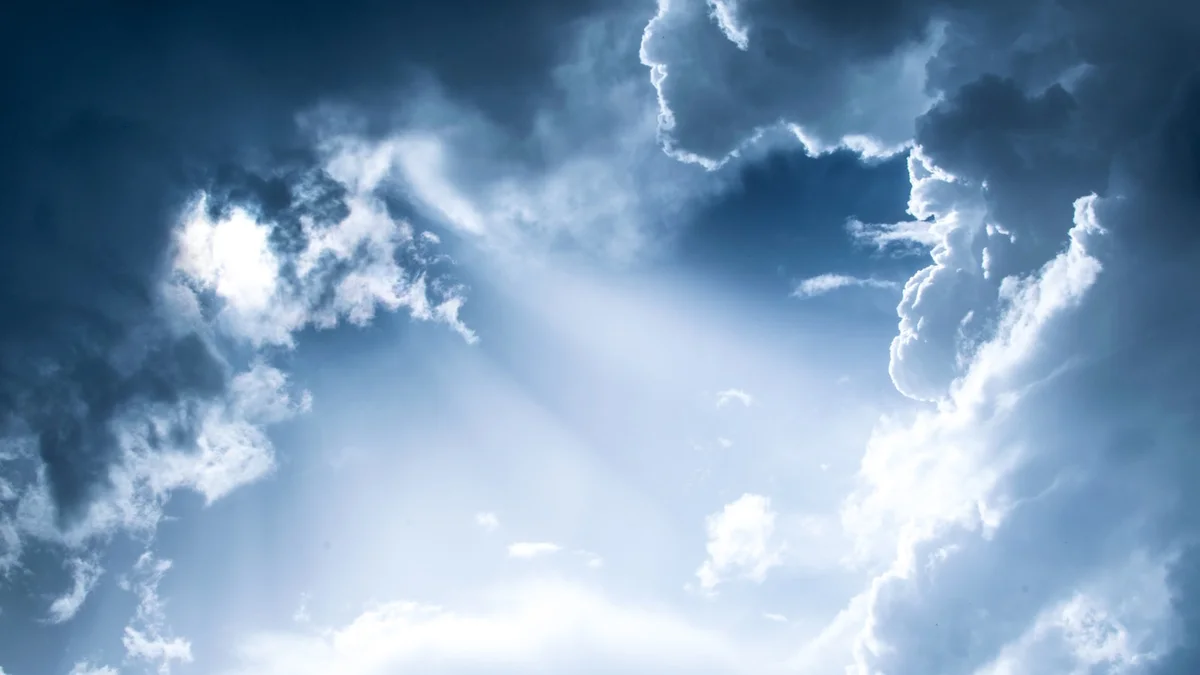Sunbeams breaking through soft clouds in a blue sky - a Quiet Core Reset guide to Self-Compassion vs. Self-Criticism.