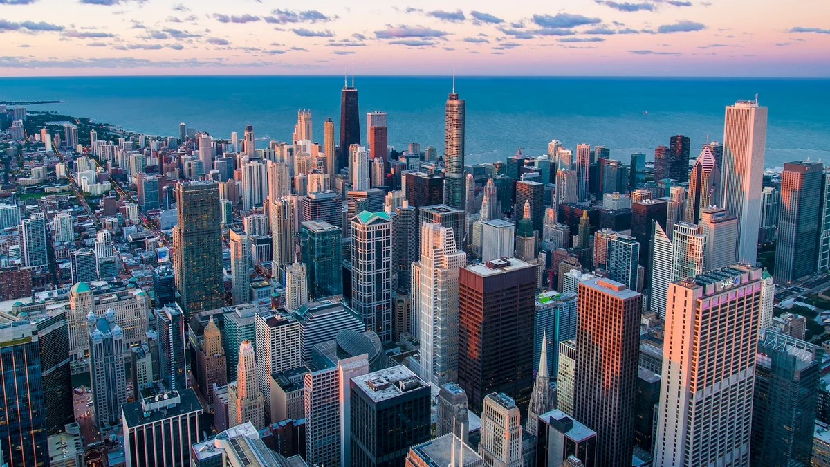A calm city skyline at dawn under soft pastel morning light - a Quiet Core Reset guide to Sleep Recovery for High Performers.