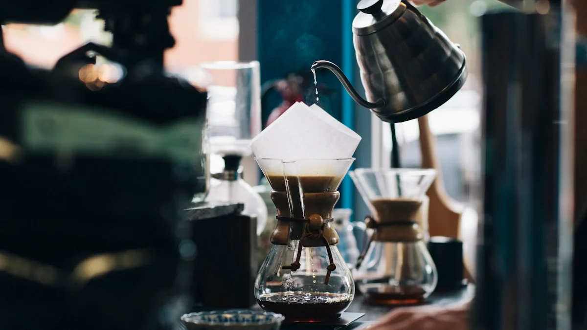Hot water poured slowly from a gooseneck kettle into a glass chemex of coffee in soft cafe light - a Quiet Core Reset guide to Slow Living Explained Simply.