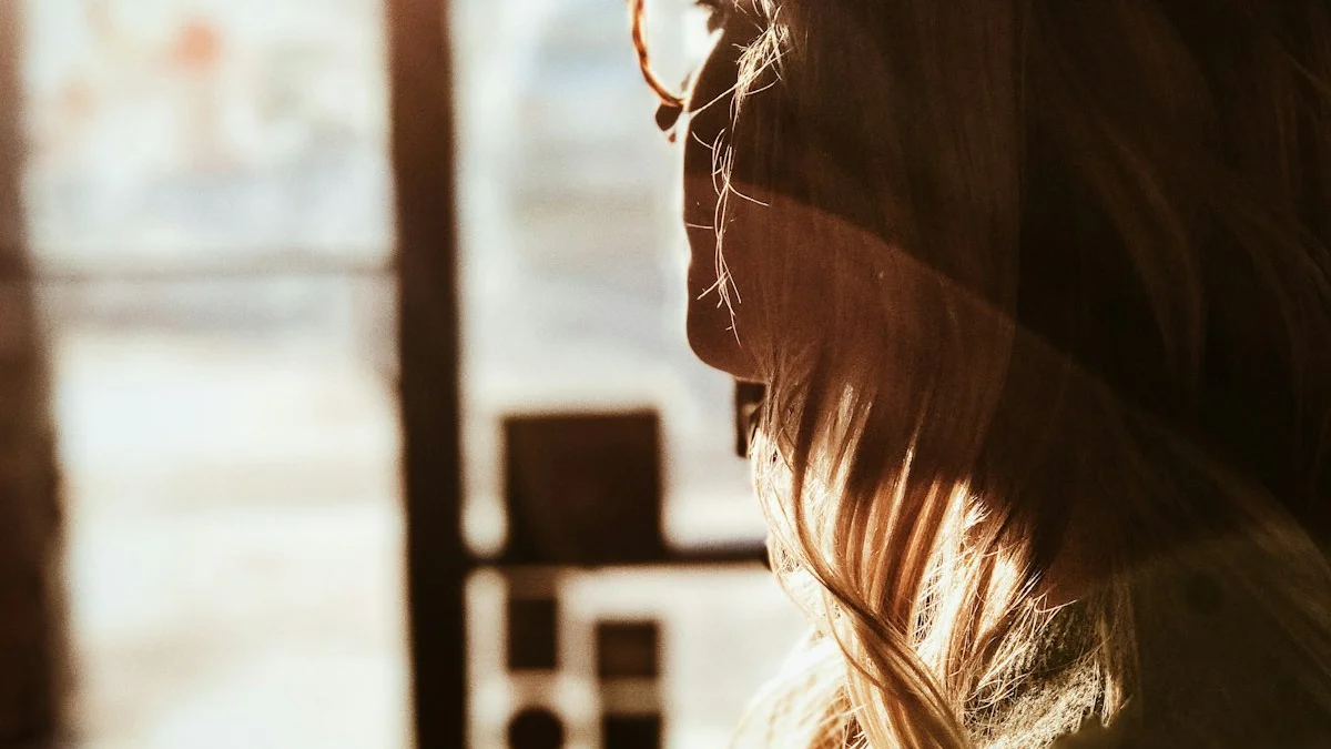 A woman pausing in golden window light, face lifted toward a bright doorway - a Quiet Core Reset guide to Slow Transitions.