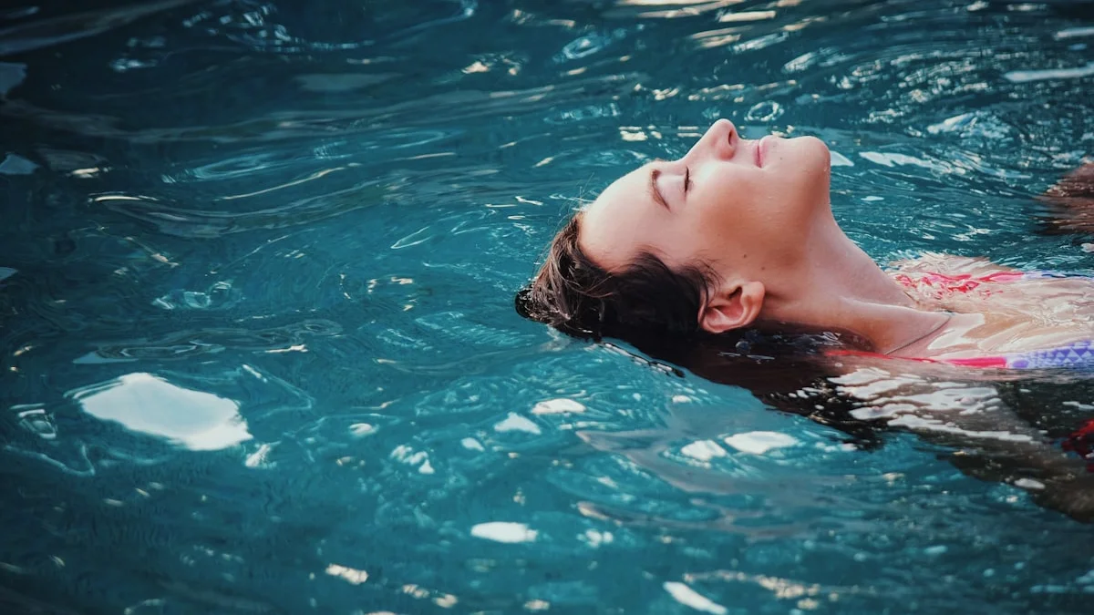 A woman floating peacefully on her back in calm blue water, eyes closed in surrender - a Quiet Core Reset guide to I Stopped Fighting My Nervous System and Learned to Regulate.
