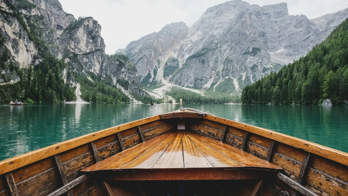 The interior of a wooden rowing boat on a calm emerald lake with cliffs around - a Quiet Core Reset guide to How I Stopped Pretending I Was Fine.