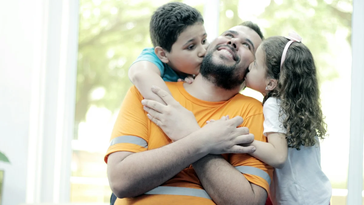 Two children kissing their smiling father on the cheek at home - a Quiet Core Reset guide to How I Stopped Snapping at My Kids Every Evening (A Real Story).