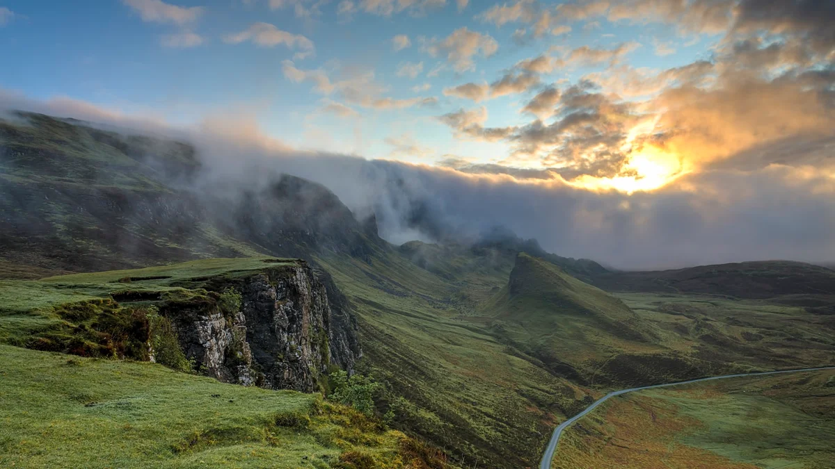 A dramatic green mountain valley with low clouds and golden sunlight breaking through - a Quiet Core Reset guide to Are You Stuck in Survival Mode? A 5-Minute Self-Check.