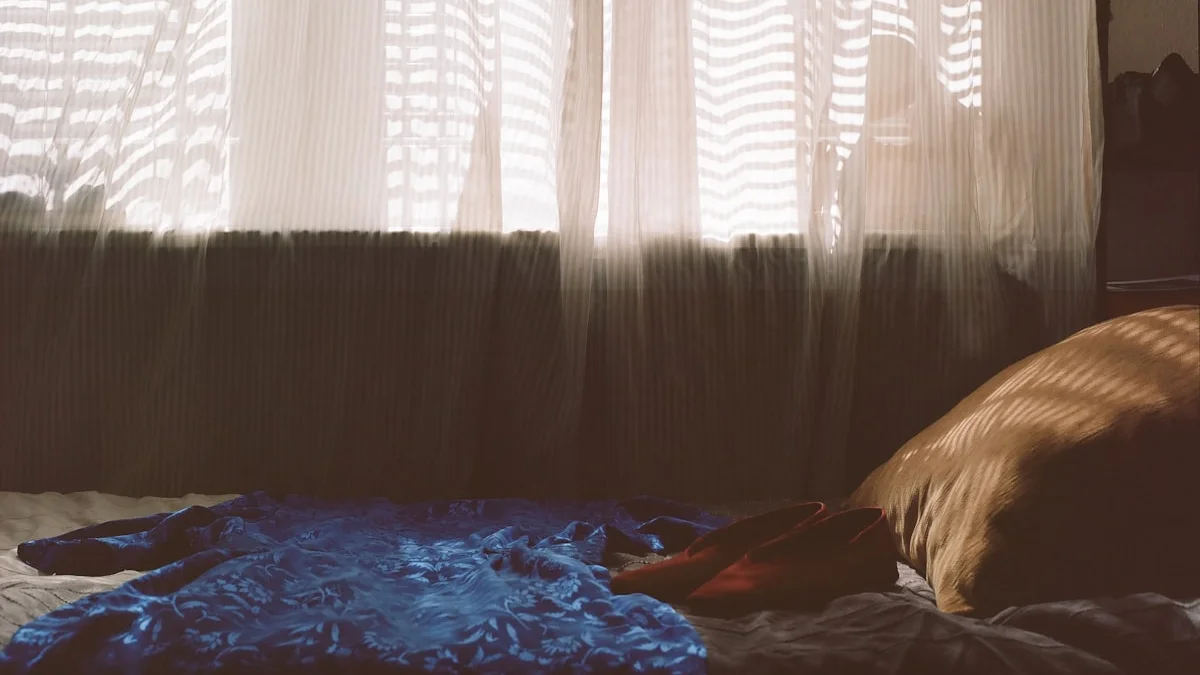 Soft morning light falling through sheer curtains onto an unmade bed, quiet and unhurried - a Quiet Core Reset guide to The Gentle Art of Allowing Yourself to Feel.