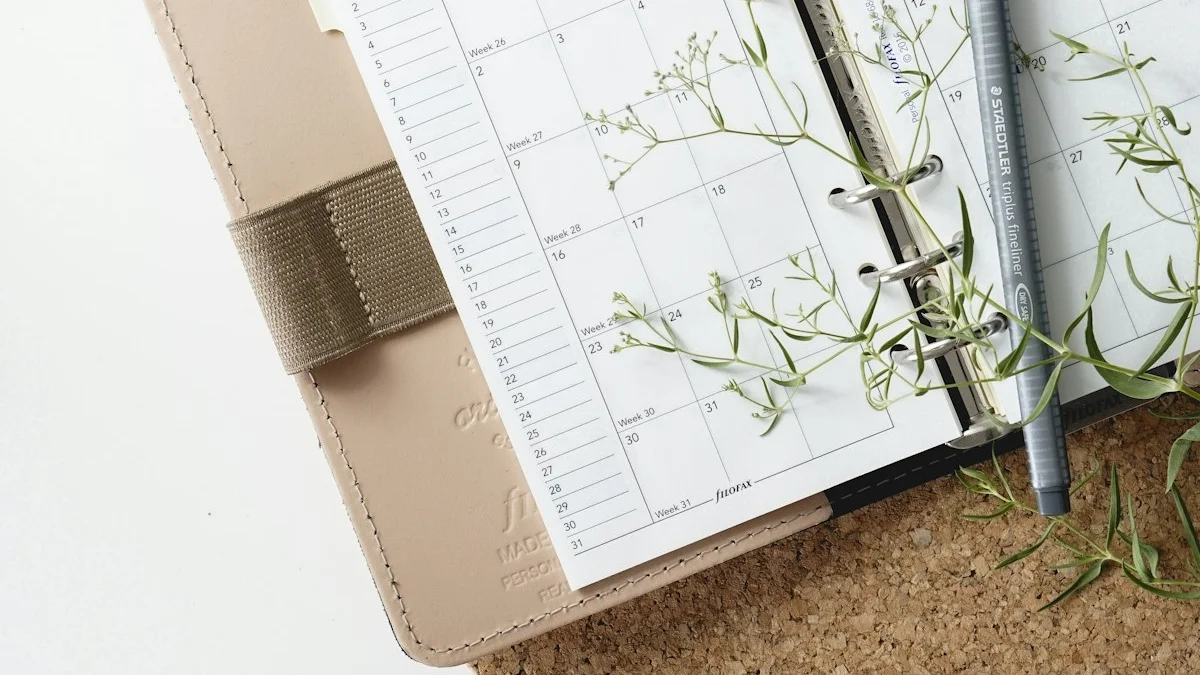 An open weekly planner with a fine-liner pen and sprigs of baby’s breath resting on its pages - a Quiet Core Reset guide to How to Unlearn the I’m So Busy Badge of Honor.