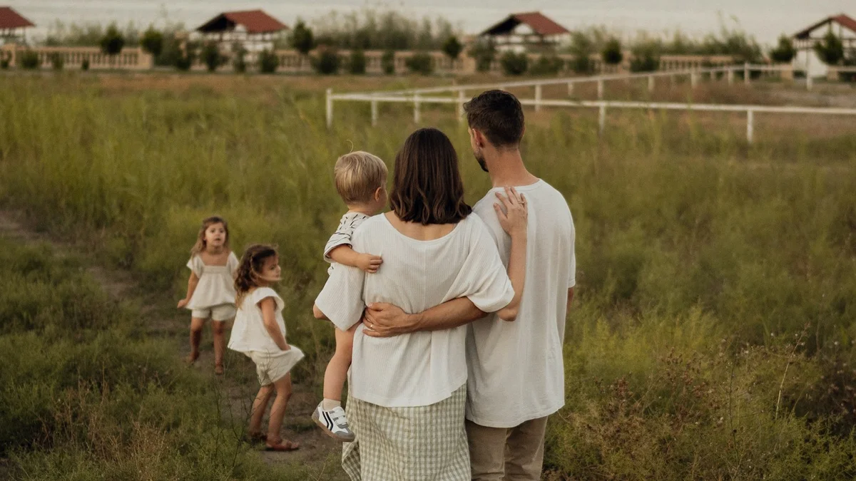 A family walking together through a golden field in soft evening light - a Quiet Core Reset guide to What Is Family Energy? The Relationship Side of Burnout Recovery.