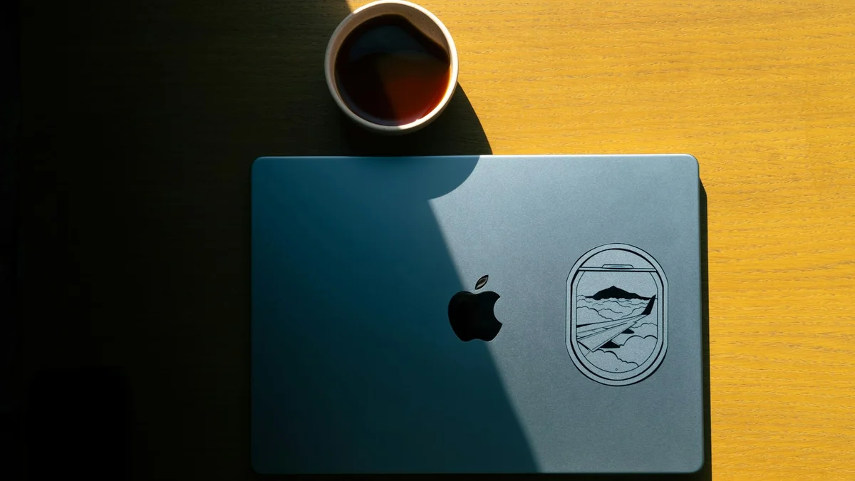 A closed laptop and a steaming cup of tea on a wooden table in warm sunlight - a Quiet Core Reset guide to What Is Work Energy? A Plain-English Guide for Tired Professionals.