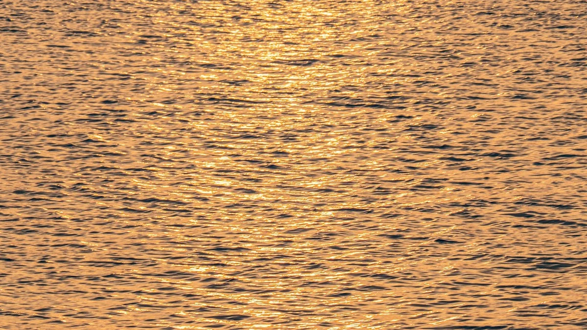 Golden light rippling gently across calm water, small waves instead of crashing surf - a Quiet Core Reset guide to Why Big Emotional Releases Backfire (And What Helps).