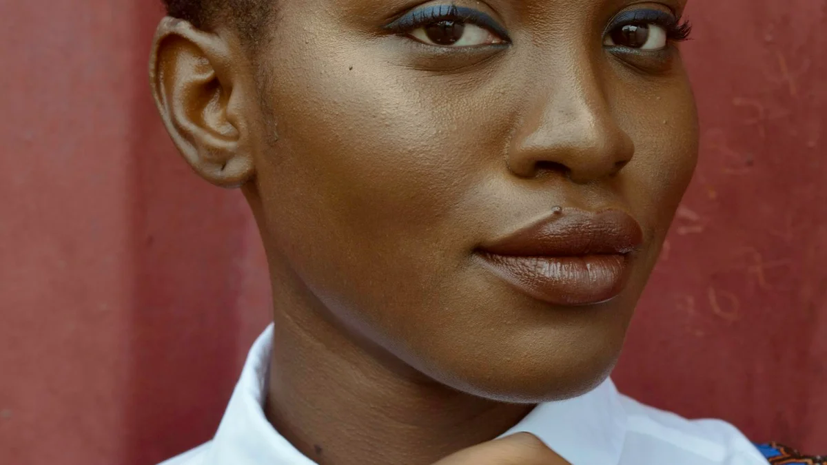 A close-up portrait of a woman looking off to the side with a calm, composed expression - a Quiet Core Reset guide to Why Guilty 'Yeses' Are Draining Your Energy.