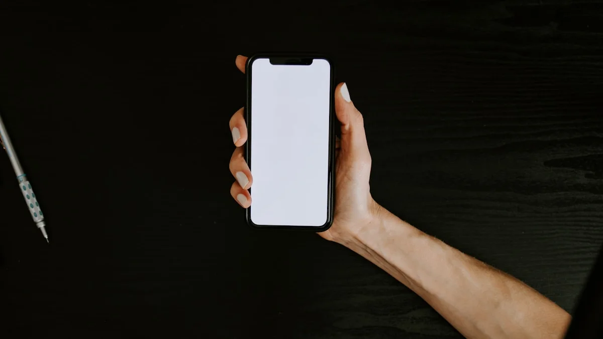 A hand holding a phone with a blank screen over a dark wooden desk, a pen waiting at the edge of the frame - a Quiet Core Reset guide to Why Saying No Got So Hard.