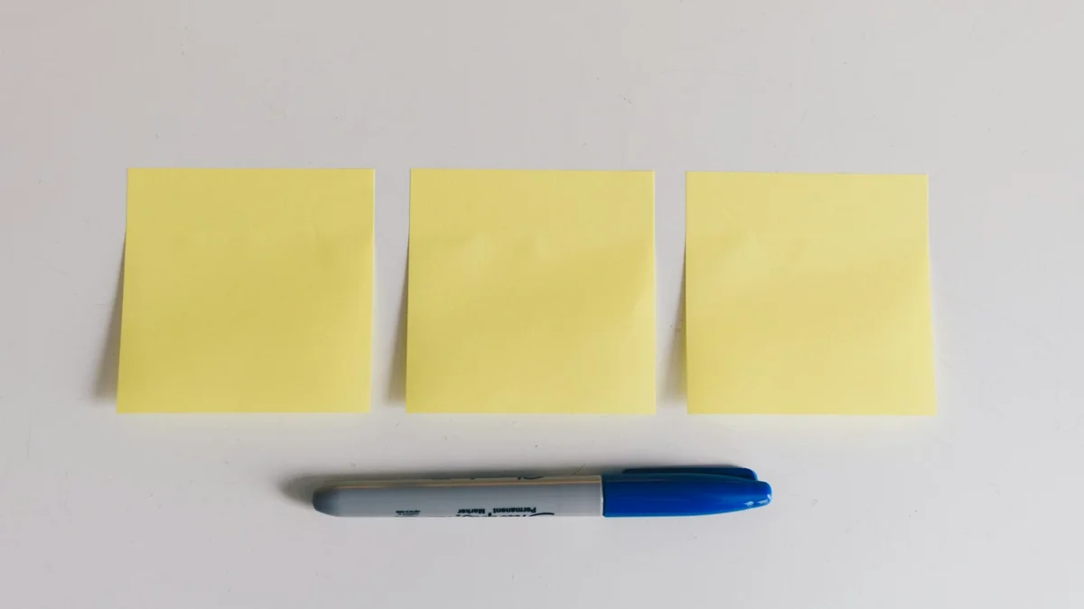 Three blank yellow sticky notes beside a blue marker - a Quiet Core Reset guide to 7 Mistakes That Drain Your Work Energy (and the Gentler Fix).