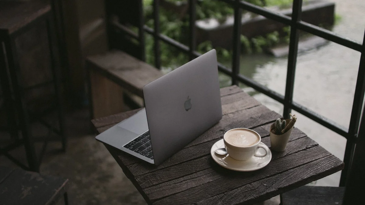 A calm desk by a window with a closed laptop and a cup of tea in soft afternoon light - a Quiet Core Reset guide to Work Energy.